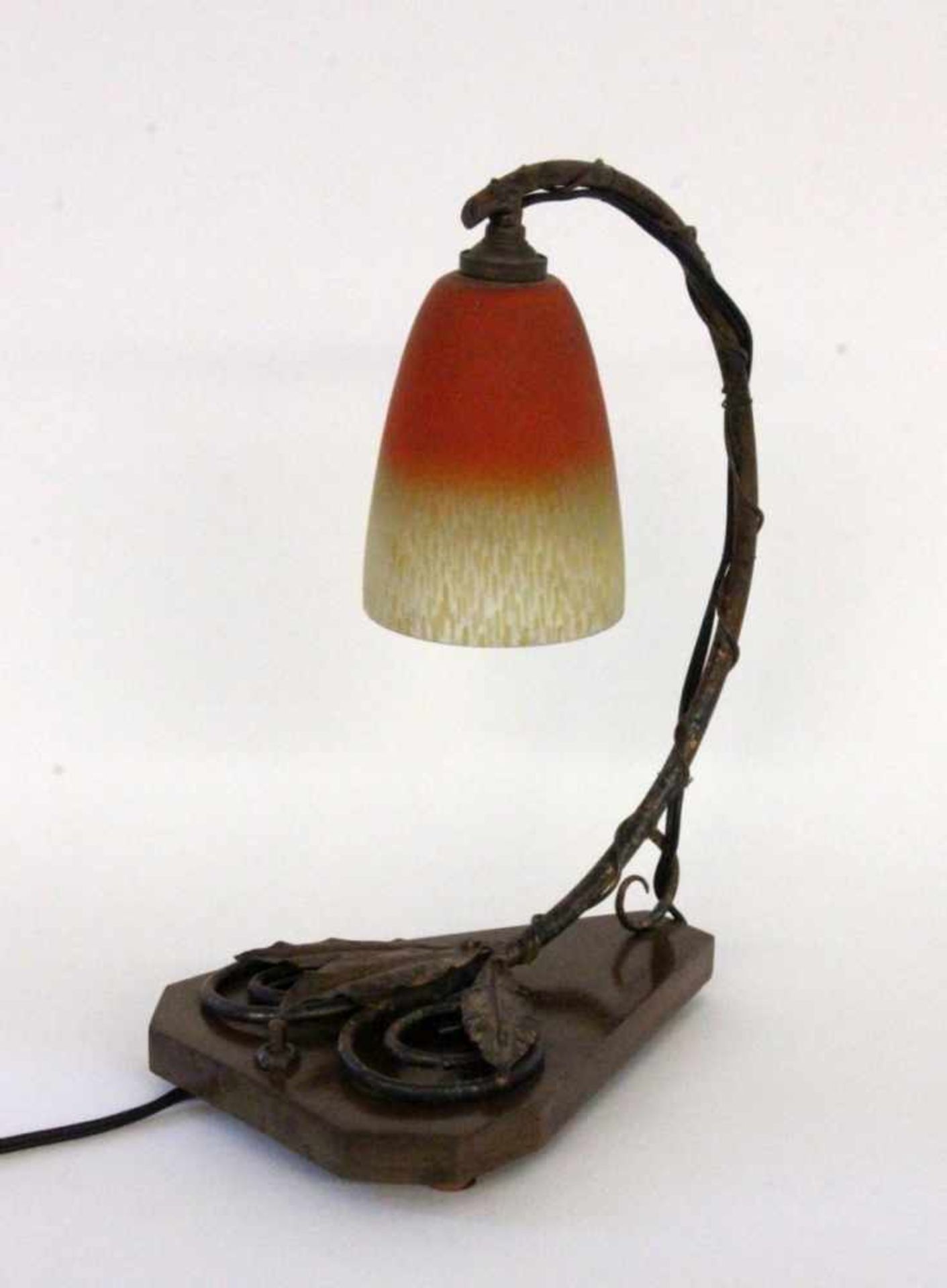AN ART NOUVEAU TABLE LAMP France, 1920s Floral decorated metal frame on wooden base. Glass