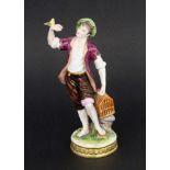 ''A MALE BIRD SELLER Volkstedt, Thuringia Colourfully decorated porcelain figure of a young