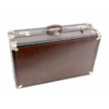 ''AN OLD SUITCASE, 1920s. Hard shell with metal fittings and leather handles. 85 x 51 x 27