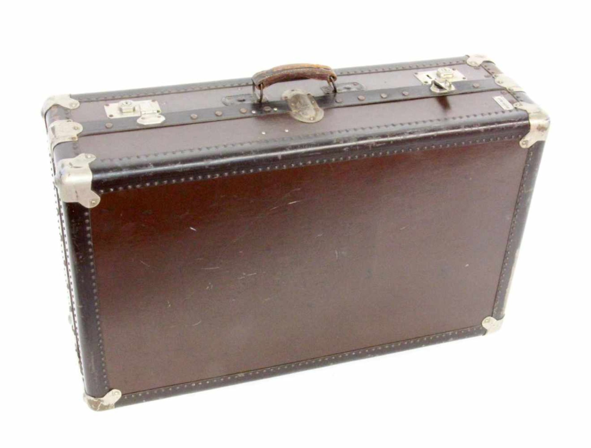 ''AN OLD SUITCASE, 1920s. Hard shell with metal fittings and leather handles. 85 x 51 x 27