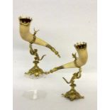 A PAIR OF DRINKING HORNS circa 1900 Gilt bronze foot with sculptural dragon. Horns at the