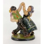 ''A DANCING PEASANT COUPLE Reddish earthenware with coloured underglaze painting. 26 cm