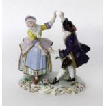 ''A DANCING PEASANT COUPLE Volkstedt, Thuringia A dancing couple with flowers on a rocaille