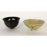 ''TWO BOWLS Probably China. Porcelain with dark grey or celadon-coloured glaze. 6 cm high,