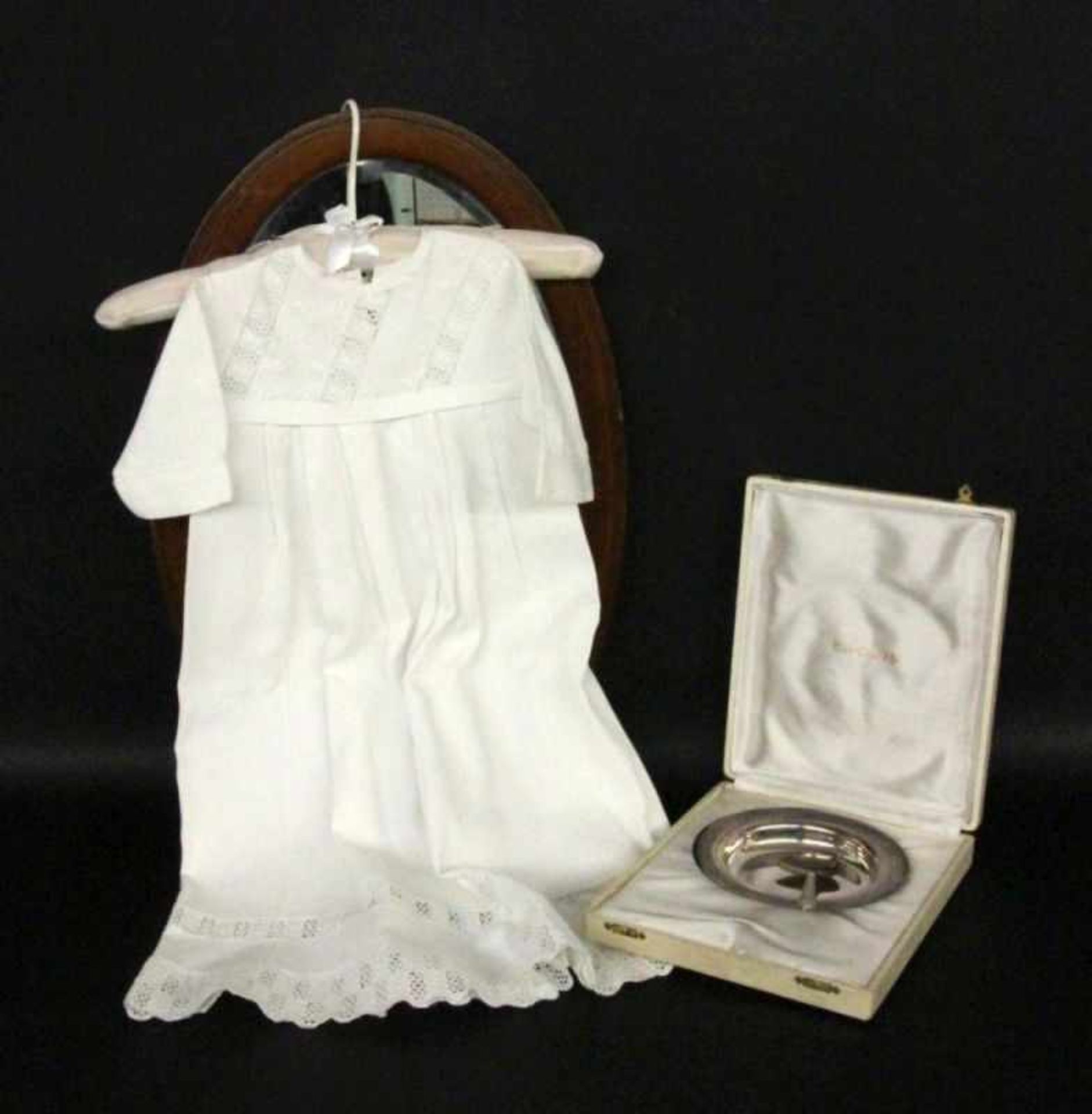 ''AN OLD CHRISTENING GOWN, white with lace trim. 65 cm long. Includes a silver-plated