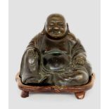 ''A SITTING BUDDHA China Patinated bronze. Wooden base. 12 cm highKeywords: Asian,