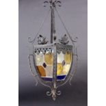 A GARDEN LANTERN Wrought-iron frame with coloured glass panels. 67 cm high. Condition: one