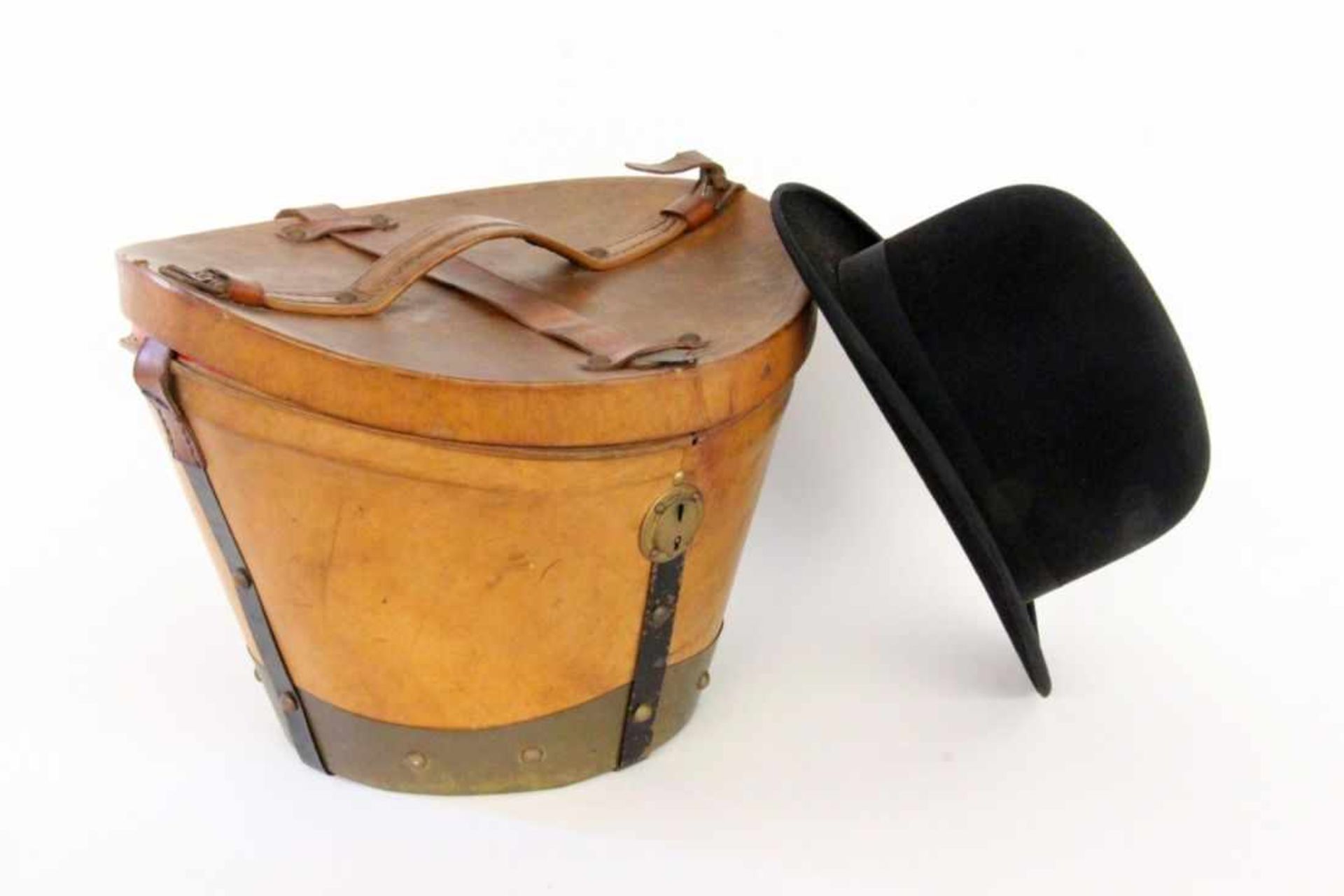 A HATBOX circa 1900 Brown leather, metal fittings, lock. (Key missing). Includes an old