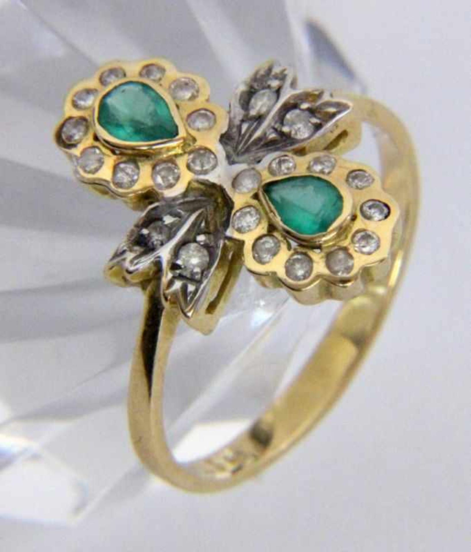''A LADIES RING 585/000 yellow gold two emeralds and diamonds. Ring size 55, gross weight