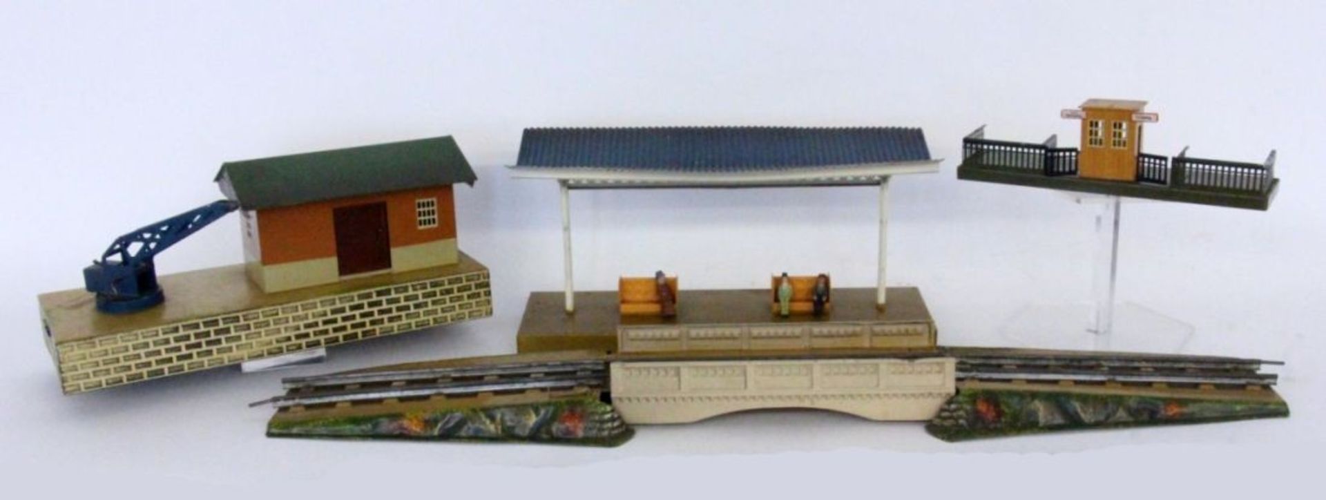 A LOT OF RAILWAY ACCESSORIES 1930s Railway platform, 36 cm long. Railway platform, 25.5 cm