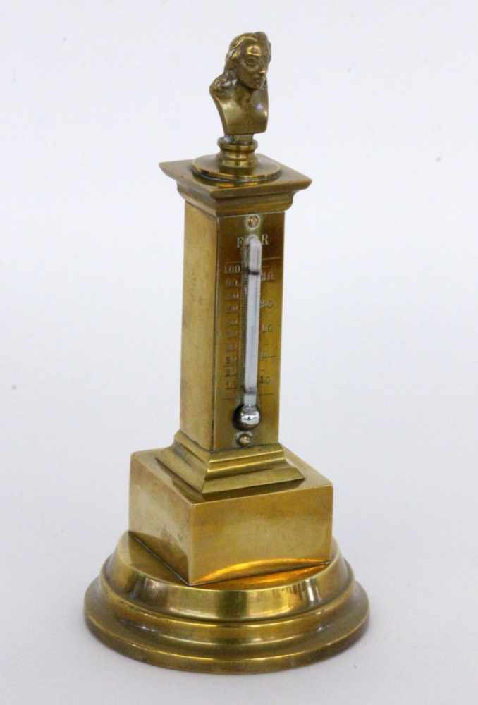 A TABLE THERMOMETER circa 1900 Brass. Topped with a sculptural bust of Anders Celsius. 19