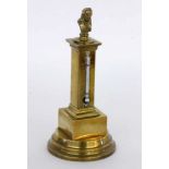A TABLE THERMOMETER circa 1900 Brass. Topped with a sculptural bust of Anders Celsius. 19