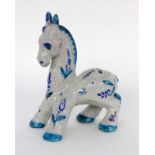 A DONKEY probably Italy, 1920s Maiolica with crazed glaze and blue ornamental painting.