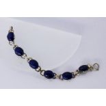 A BRACELET Silver, gold-plated with lapis lazuli. 17.5 cm long. Keywords: jewellery, piece