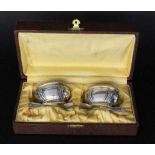 A PAIR OF SALT BOWLS Silver-plated metal with gilt interior, glass inserts and 2 spoons. With