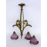 AN ART NOUVEAU HANGING LAMP Bronze frame with 4 purple veined glass shades. The wiring and