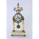 A PORTICO CLOCK France, late 19th century Yellow-spotted marble with gilt bronze fittings.
