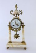 A PORTICO CLOCK France, late 19th century Yellow-spotted marble with gilt bronze fittings.