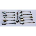 A LOT OF 11 SOUVENIR SPOONS Silver, partly gilt, mostly with enamelled views and coats ofarms from