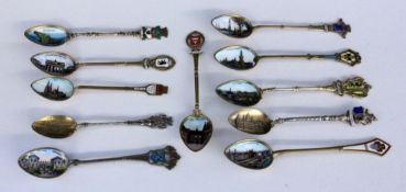 A LOT OF 11 SOUVENIR SPOONS Silver, partly gilt, mostly with enamelled views and coats ofarms from