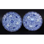 TWO PLATES China, probably Qing dynasty Flat round shape with fanned edge. Blue underglaze