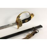 AN INFANTRY OFFICER’S SWORD Prussian circa 1900. Black iron scabbard. Brass hilt with Prussian