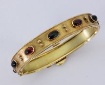 A BANGLE 750/000 yellow gold with 5 green and 4 red tourmaline cabochons. Handmade. Inside