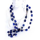 A NECKLACE with lapis lazuli nuggets and cultured pearls. 89 cm long, metal clasp.