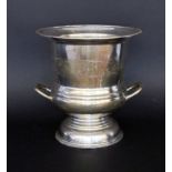 A CHAMPAGNE COOLER Silver-plated metal. Krater-shaped with engraved decoration and handles. 25 cm