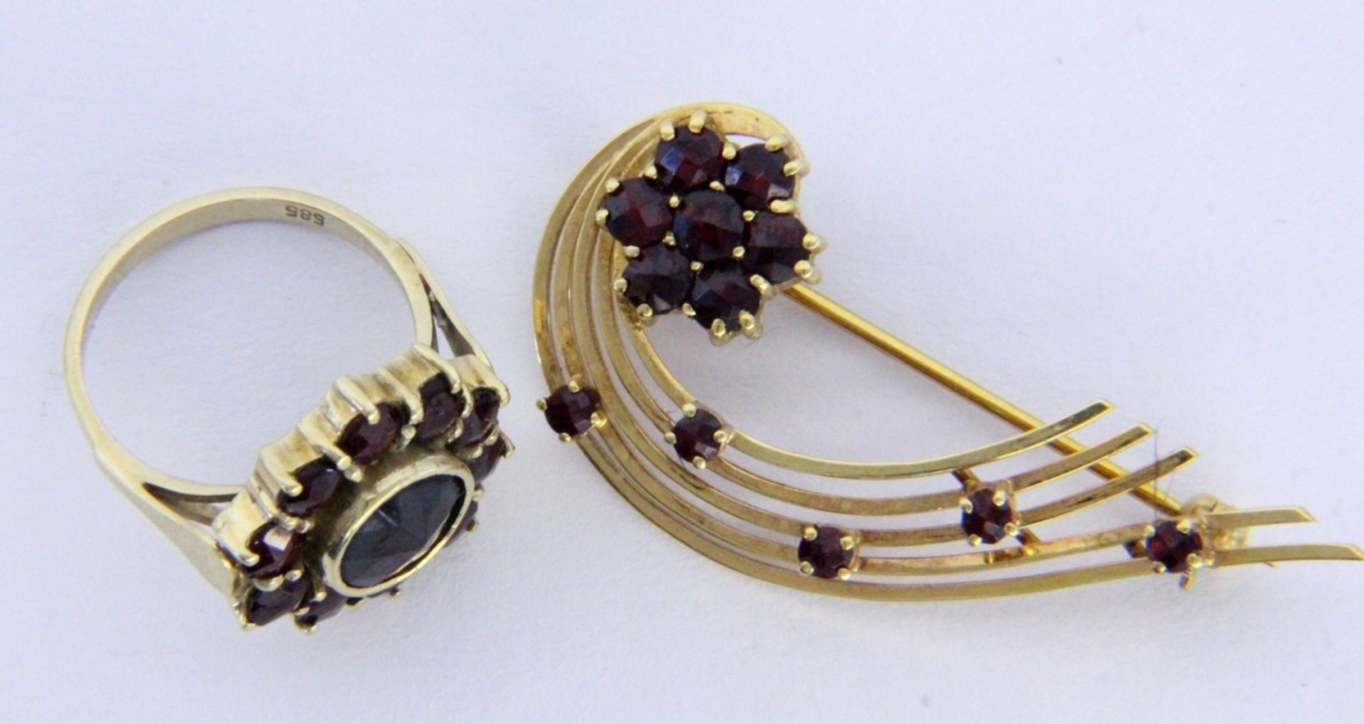 A GARNET BROOCH AND GARNET RING 585/000 yellow gold. Ring size 52, gross weight approx.