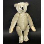 A SMALL STEIFF TEDDY BEAR with light-grey mohair fur. Button eyes, button in the ear and