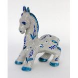 A DONKEY. Maiolica with crazed glaze and blue ornamental painting. Unclear impressed mark.