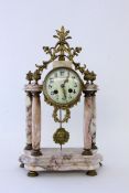 A PORTICO CLOCK France, late 19th century Grey spotted marble. Gilt brass case with bronze fittings.