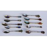 A LOT OF 10 SOUVENIR SPOONS Silver, partly gilt, mostly with enamelled views and coats ofarms from