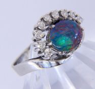 A LADIES RING 585/000 white gold with opal doublet and 9 brilliant cut diamonds totalling