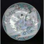 A WALL PLATE China, probably Qing dynasty Figurative painting in the colours of the