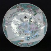 A WALL PLATE China, probably Qing dynasty Figurative painting in the colours of the