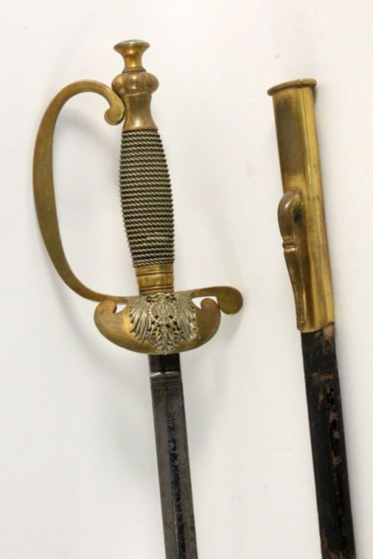 AN INFANTRY OFFICER’S SWORD Prussia, 19th century Leather scabbard with brass fittings. Ornate steel