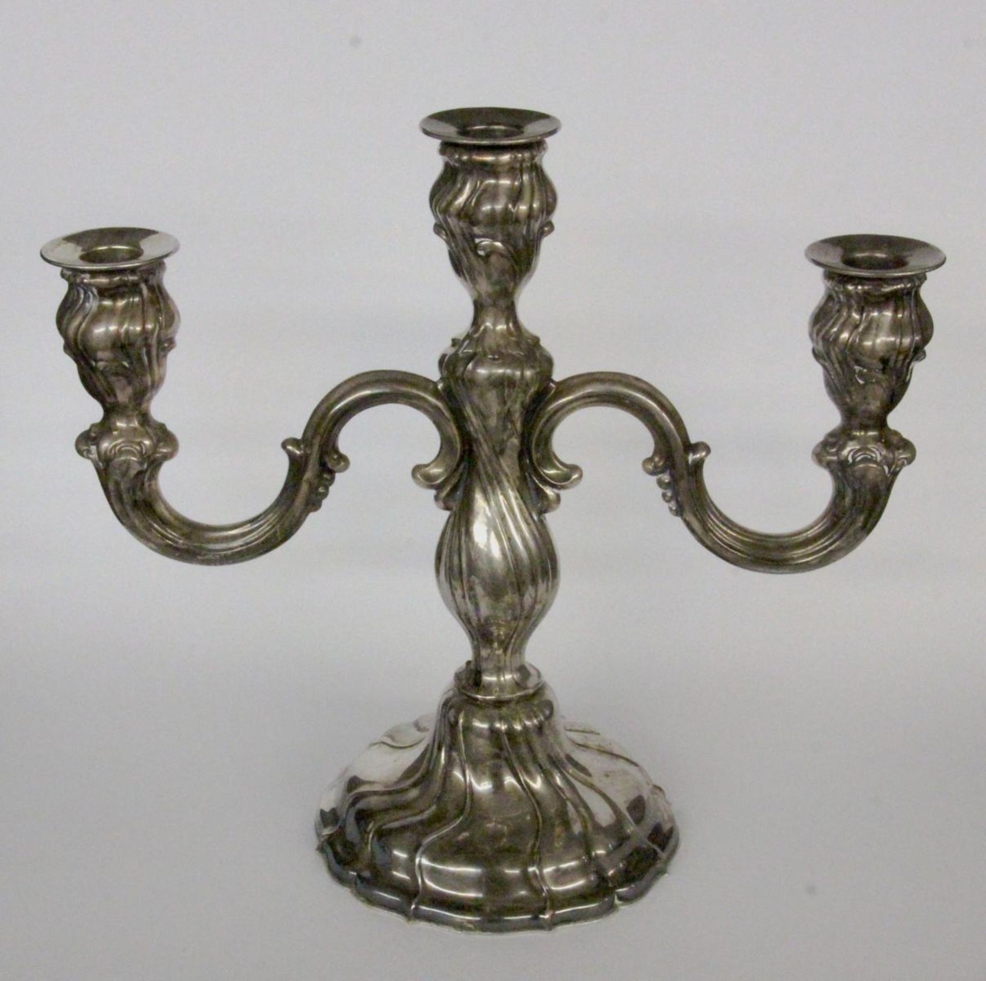 A CANDLESTICK Wilhelm Binder, Schwabisch Gmund circa 1900 Silver 800. 3-light, Baroque