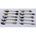 A LOT OF 10 SOUVENIR SPOONS Silver, partly gilt, mostly with enamelled views and coat of