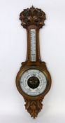 A WEATHER STATION England 1914 Carved walnut frame with thermometer and barometer. With