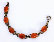 A BRACELET Silver, gold-plated with carnelian cabochons. 15 cm long. Keywords: jewellery,