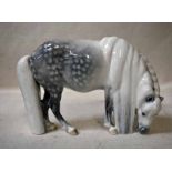 A Royal Copenhagen porcelain model as a Shetland Pony grazing, with long mane and tail, printed