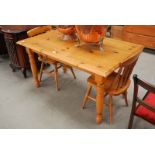 A 4FT 6INCH PINE KITCHEN TABLE & A PAIR OF SPINDLE BACK DINING CHAIRS