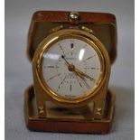 A 20th century small Ardath Travel Alarm Clock, set in a horseshoe style frame, within a pig skin