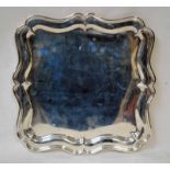 An Edwardian silver four-footed Tray, shaped square form with raised edge and lip, Sheffield 1913,