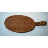 Robert 'Mouseman' Thompson of Kilburn (1876-1955) an oak Cheese Board, oval paddle form with