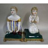 A Bloor Derby porcelain figure of a girl kneeling on a green cushion tying her shoe laces and a