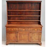 An 18th century Georgian Elm Dresser, the rectangular pot board with plain cornice, vertically