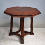 After Sir Robert Lorimer, a Liberty style fumed Oak Table, octagonal moulded edge top on typical